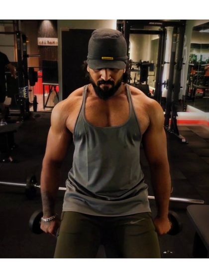 FOCUS. A moment of concentration before starting a set of dumbbell lateral raises for shoulder width.