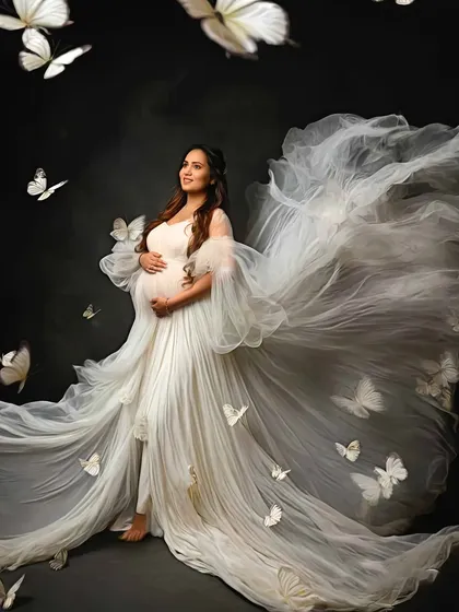 A breathtaking portrait with a flowing white gown and a cascade of butterflies, creating a truly magical and transformative image.