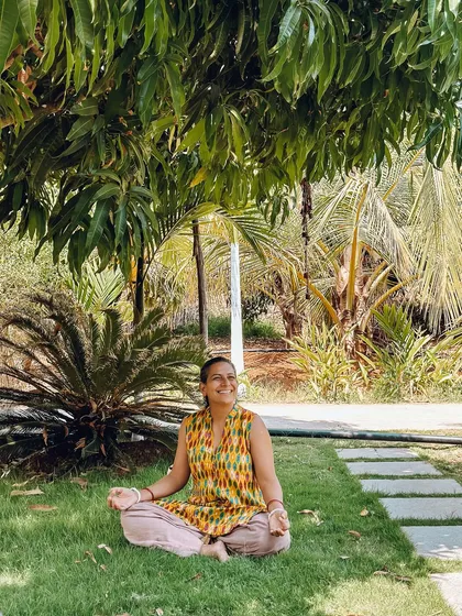 A student finds a peaceful spot to meditate in the ashram's garden. There are many quiet corners here to connect with yourself and with nature.