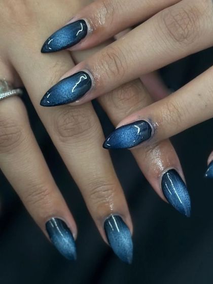 A close-up of the dark cat-eye stiletto nails. The subtle shift in the magnetic polish gives these nails incredible depth and dimension.