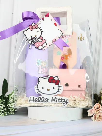 A beautifully arranged "Hello Kitty" hamper, featuring a personalized water bottle, utility pouch, and cardholder, all packed in a clear tote bag.