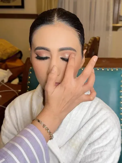 The process begins with creating a perfect canvas. Here, I'm applying a shimmering eyeshadow base to catch the light, while the skin is prepped and ready for a majestic, glowing bridal look.