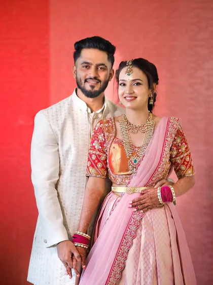 Such a sweetheart couple. For this bride to be's engagement, we chose a romantic look with a pink lehenga, pairing it with soft makeup that highlighted her happy glow.