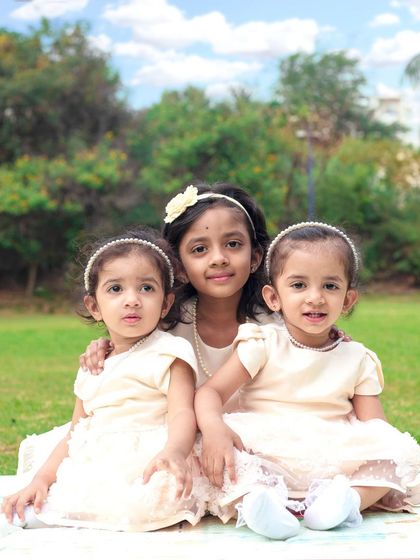 A fun outdoor session with three sisters. I love capturing the natural light and genuine interactions of children playing together in a park setting.