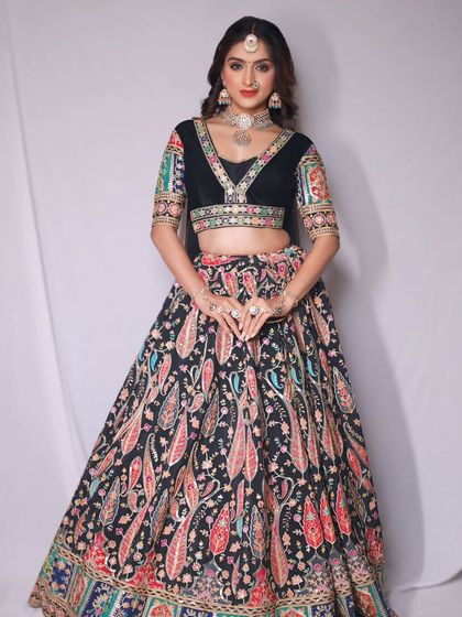 For a bold and stylish look, I suggest this black lehenga with a vibrant, multi-colored paisley print. The velvet blouse adds a touch of luxury, making it perfect for an evening sangeet or cocktail party.