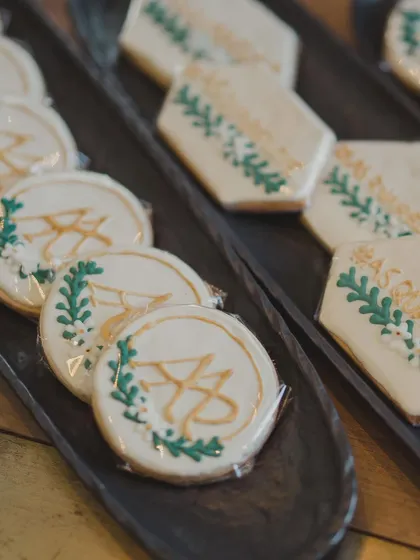 Custom-made cookies featuring the couple's monogram and wedding motif. These edible favors are a sweet and elegant way to thank guests for being part of the celebration.