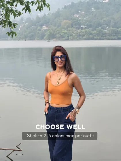 A key principle of looking expensive is choosing your colors well. Sticking to 2-3 colors per outfit, like the orange and denim blue here, creates a cohesive and polished look.