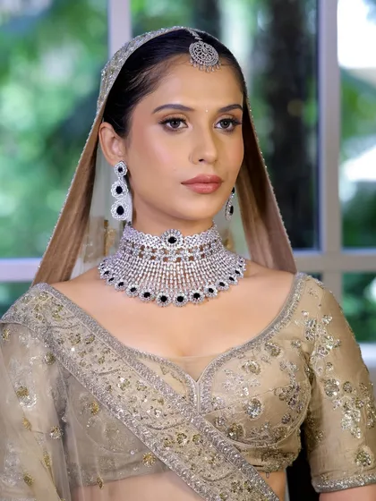 A beautiful portrait of the ivory bridal look. The makeup is soft and luminous, perfectly complementing the diamond and sapphire choker.