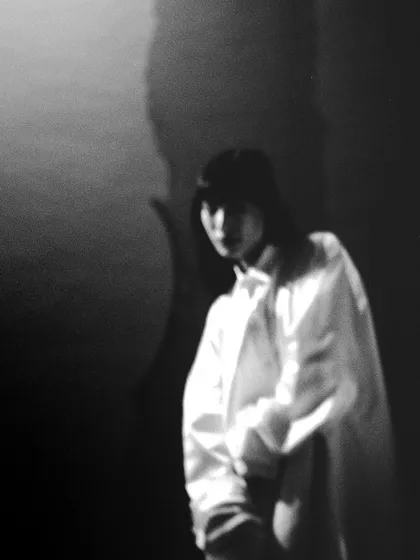 A blurry, abstract portrait of 'Henna' on film. The lack of sharp focus and the play of shadows create an enigmatic and purely artistic image.