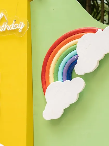 A rainbow and cloud prop from the Cocomelon setup, showcasing the colorful and imaginative details of the theme.