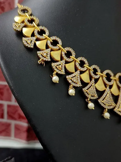 A close-up of the geometric necklace from this modern set.
