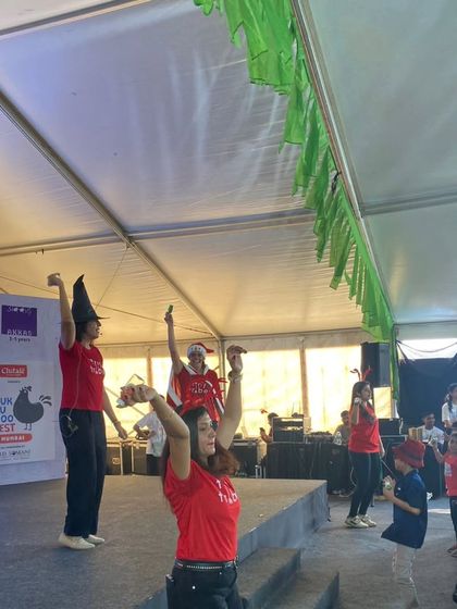 Our teachers, dressed as elves with pointy hats, lead the audience in a fun, interactive movement activity during our Christmas show. We believe in getting everyone up and moving to the music.