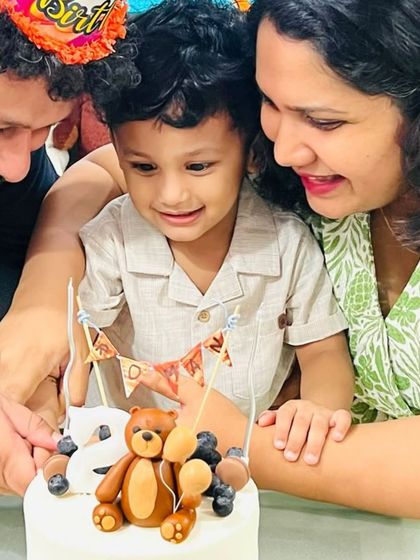 A close-up of the birthday boy admiring his teddy bear cake. These are the moments that make all the hard work worthwhile.