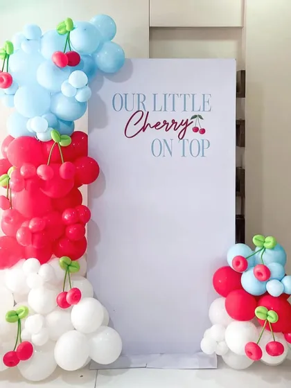 We designed this "Our little Cherry on top" theme for a special celebration. The balloon columns are made of red, white, and light blue balloons, with adorable hand-twisted cherry balloon accents throughout.