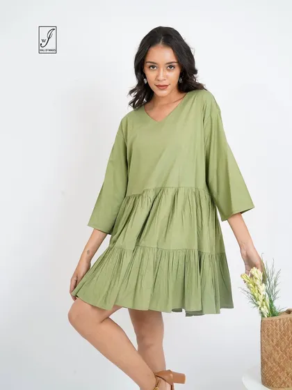 A pose that highlights the dress's details, with the model holding a bouquet of flowers.