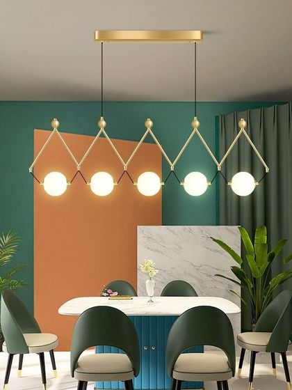 Here is a linear chandelier with five globe lights, ideal for placing over a long dining table. The geometric design with its gold finish is very contemporary and provides excellent task lighting for meals and gatherings.