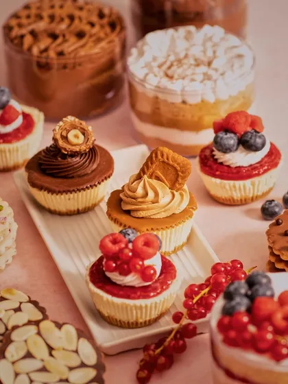 This shot is all about abundance and variety. We created a delicious-looking spread of cupcakes and desserts, using a warm, soft light to highlight the creamy textures and fresh berry toppings.