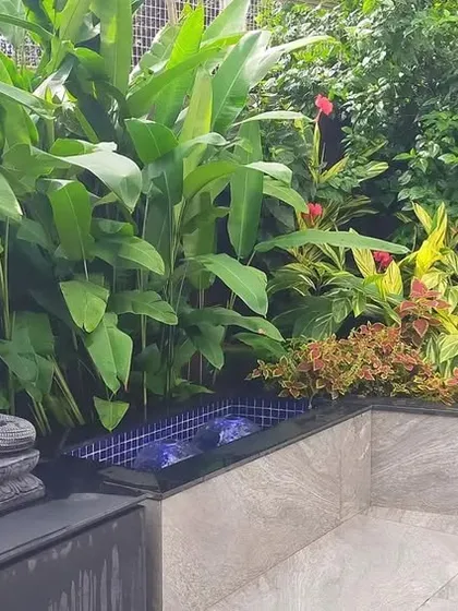 This project highlights our capabilities in complete garden landscaping using artificial elements. We designed a tranquil space featuring a mix of large-leafed faux plants, a serene Buddha statue, and a small water feature, all requiring minimal upkeep.