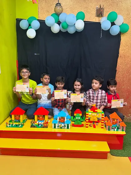 Success and teamwork are celebrated at Junior Engineers. A group of our students proudly hold their completion certificates after a LEGO workshop, showcasing the unique houses they each designed and built. Every child leaves with a sense of accomplishment and new skills.