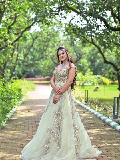 A classic full-length shot of the pastel green embroidered gown, showcasing its timeless beauty.