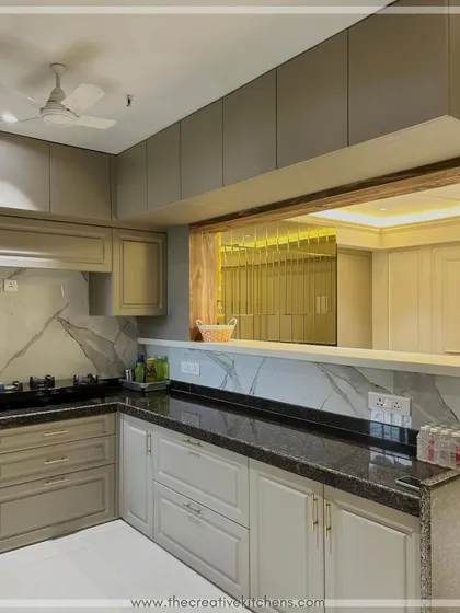 This view shows the open-concept design, with a pass-through window connecting the kitchen to the adjoining living space. This feature enhances the sense of openness and makes entertaining a breeze.
