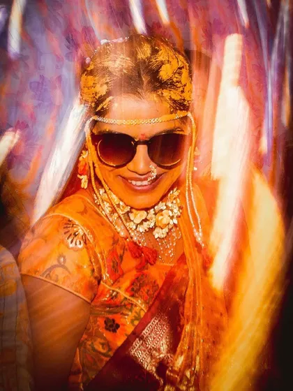 A creative, motion-blur photo of the bride during her Haldi. The vibrant colors and her happy smile shine through, capturing the high-energy vibe of the event.