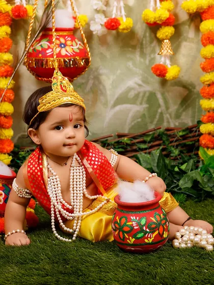 A sweet baby Krishna posing for the Janmashtami mini session announcement.