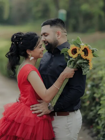An intimate embrace in a lush Pune garden. The soft focus and natural light enhance the romantic and heartfelt nature of this candid engagement photo.