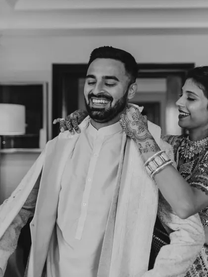 It’s the small, behind-the-scenes moments that I cherish. Here, I'm helping the groom's brother with his outfit, which we repurposed by dyeing his wedding sherwani a new color. It’s a great way to make wedding wear sustainable and create new memories with beloved pieces.