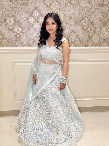 A full-length shot of the client in her elegant lehenga.