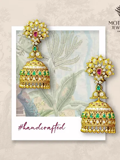 Handcrafted for a special occasion, these traditional gold jhumka earrings are adorned with rubies, emeralds, and diamonds. A perfect example of our bespoke design capabilities for bridal clients.