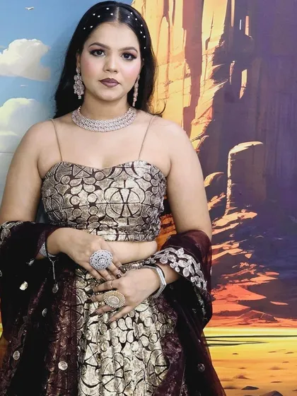 This printed gold and maroon lehenga set is perfect for a festive occasion. It's paired with a simple diamond choker and statement rings.