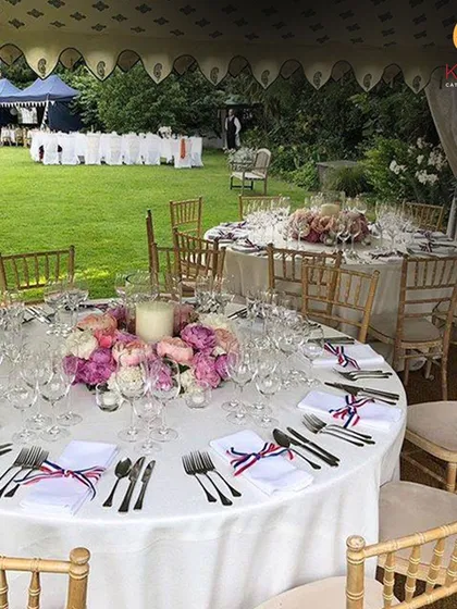 A beautifully arranged sit-down lunch at a sun-kissed garden party. The elegant table setting, complete with floral centerpieces and fine cutlery, highlights our ability to create sophisticated outdoor dining experiences for weddings and private celebrations.