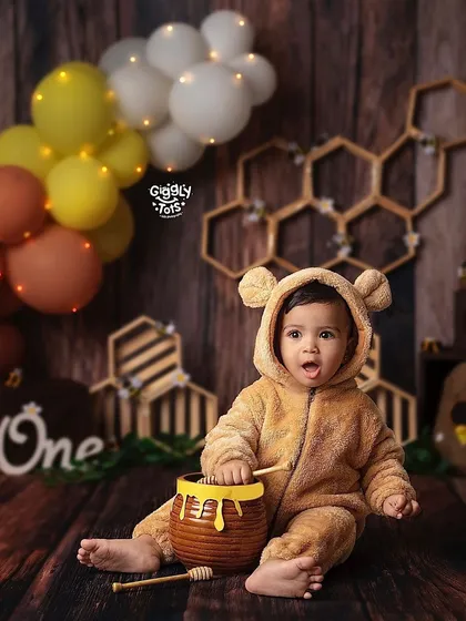 Enjoying the sweetness of life! This little one, dressed as a bear, is having a wonderful time with his honey pot.