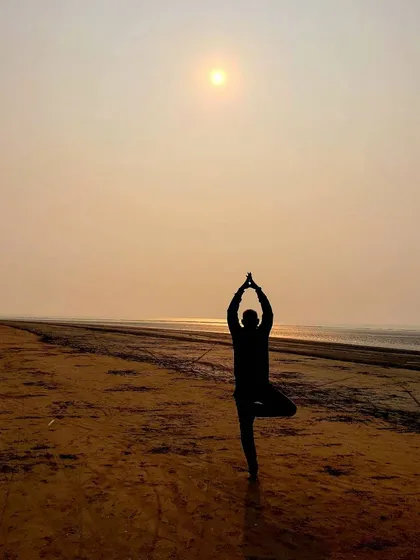 Practicing Vrikshasana, or Tree Pose, as the sun sets over the water. This pose teaches us balance and stability, drawing strength from the earth. Moments like this remind us that we are a part of nature, reflecting its beauty and resilience.