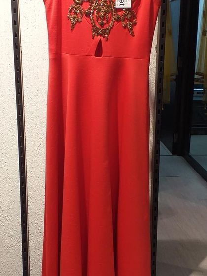 A simple yet elegant red gown with a keyhole neckline and gold embroidered motif. This piece is a great example of the high-end designer labels you can find at a steep discount in our store.