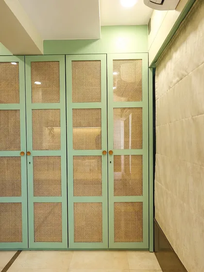 A close-up of the board-and-batten style wardrobe doors in a beautiful Dutch green, showcasing our love for unique color combinations.