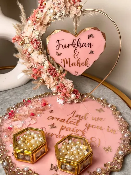 The full view of the heart hoop ring platter. The geode-style tray is decorated with pearls and a Quranic verse, and the ring boxes are filled with pearls.