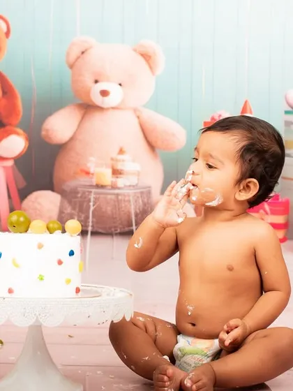 Getting a little messy is part of the fun. This shot captures the joy of a baby enjoying their first birthday cake.