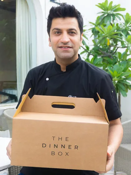 We are proud to partner with global food icon Chef Kunal Kapur. Here he is with our signature Dinner Box, ready to deliver his curated '7 Gulabi Bagh' menu.