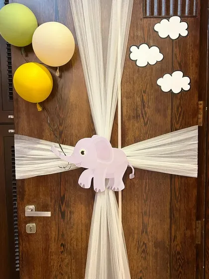 A simple yet adorable zoo-themed door decoration to welcome home a new baby boy, featuring a cute elephant and soft tulle.