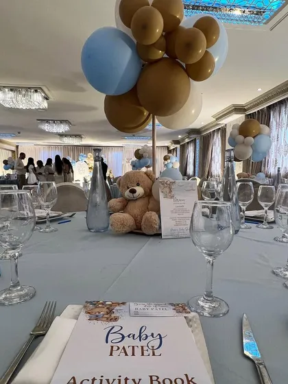 The guest tables were decorated with matching teddy bear centerpieces, custom activity books, and menus, ensuring the theme was carried throughout the entire venue.