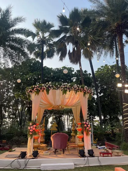 A lovely pastel-themed mandap perfect for a daytime garden wedding. The soft peach drapes and floral arrangements create a light and airy feel, ideal for an intimate ceremony.
