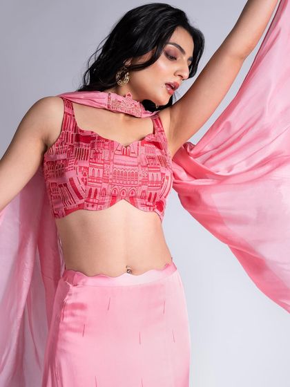 A close-up of the makeup for this pink printed top. The look features a soft pink eyeshadow and a matching lip color to create a cohesive, monochromatic style.