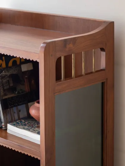 The Aamira storage unit is a piece with details galore. It can function as a bookcase, crockery unit, or bar, and features finger grooves, stained glass, and brass inserts, making it a statement piece for any living or dining area.