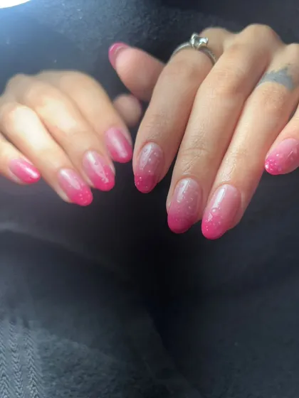 A simple yet vibrant set of nails with a pink glitter ombre effect.