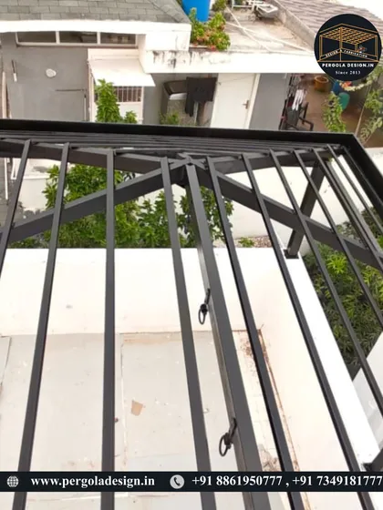 A detailed shot of the pergola's framework, showing the hooks installed for hanging lights or plants.
