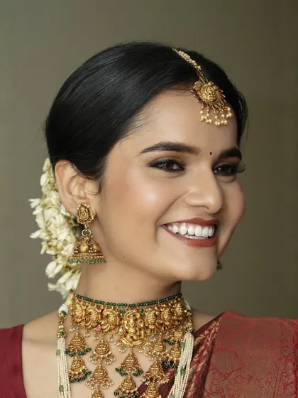 A joyful, smiling close-up that shows how the makeup comes alive with the bride's expressions. The bright eyes and warm smile are the heart of this beautiful traditional look.
