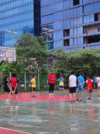 A coach gives instructions during a rainy day session. We adapt our training to the conditions, but the hustle never stops.