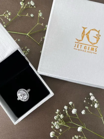The promise of forever, beautifully packaged. This oval diamond ring with a double halo is a testament to exquisite craftsmanship. It represents the start of a new chapter, presented with the care and luxury it deserves.